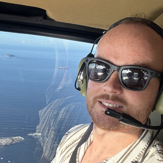 Nathan Mueller smiling during a helicopter flight
